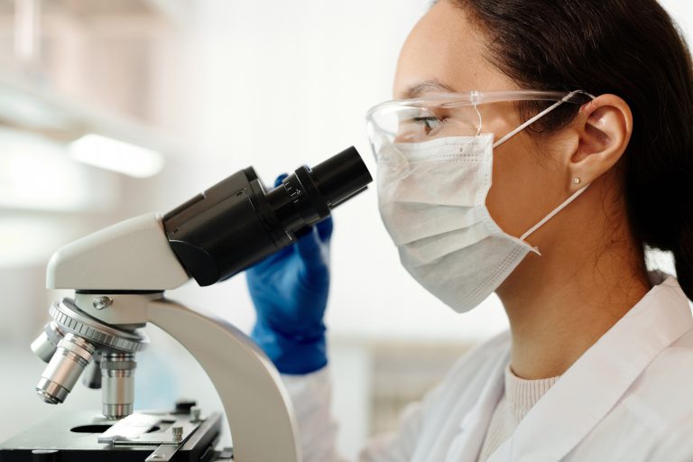 Preclinal Scientist woman looking in a scope