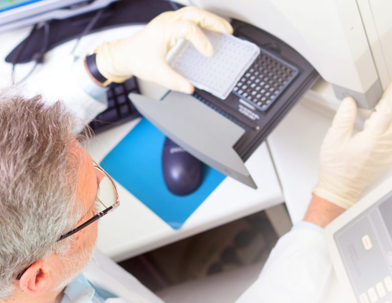 Life science researcher performing a genotyping testing which enables personalized medicine. PM is a medical model that proposes the customization of healthcare.